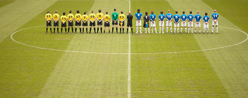 soccer players lined up at midfield